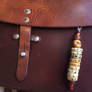 bagcharm, mani headhunter with bone skull